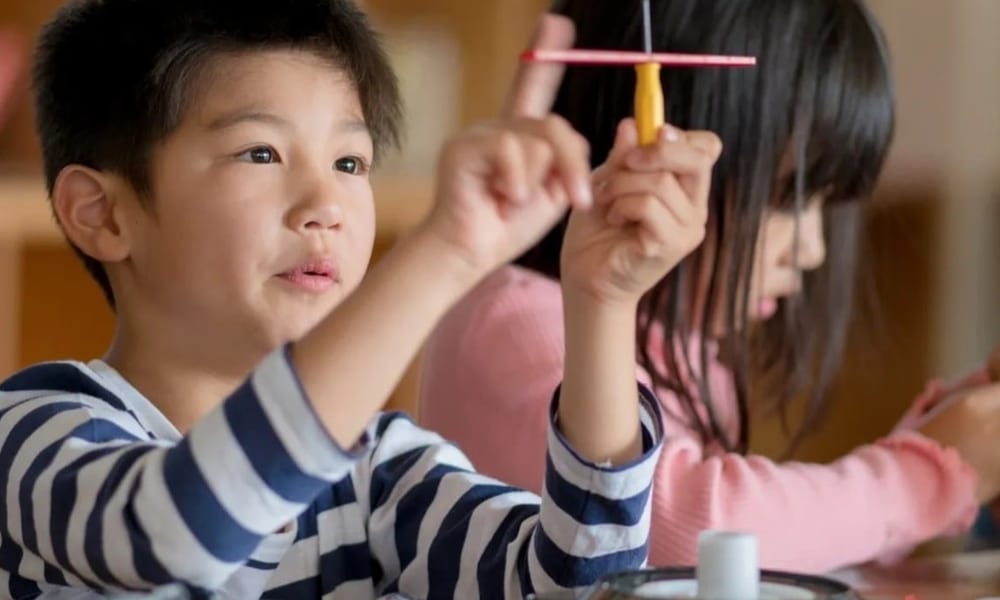 Pre-K students engaged in advanced STEM experiment