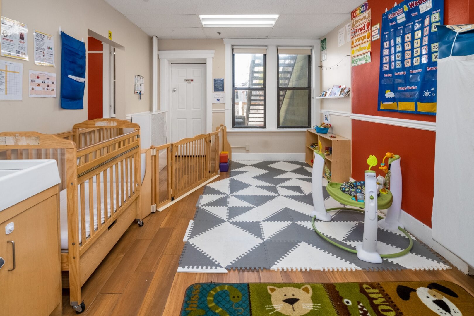 Padded floor mats and activity toys in the Smart Start Academy infant room