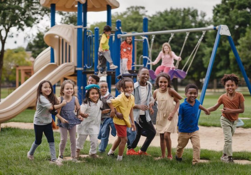 Children running and smiling at playground